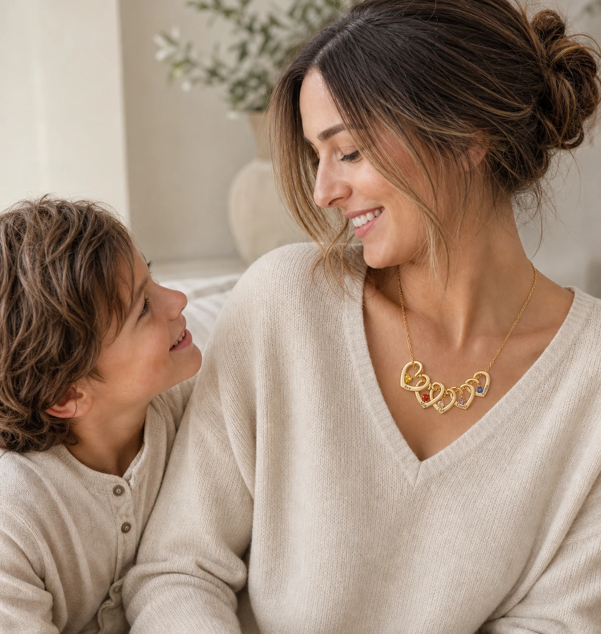 Mother and child sharing a moment while wearing engraved family jewelry