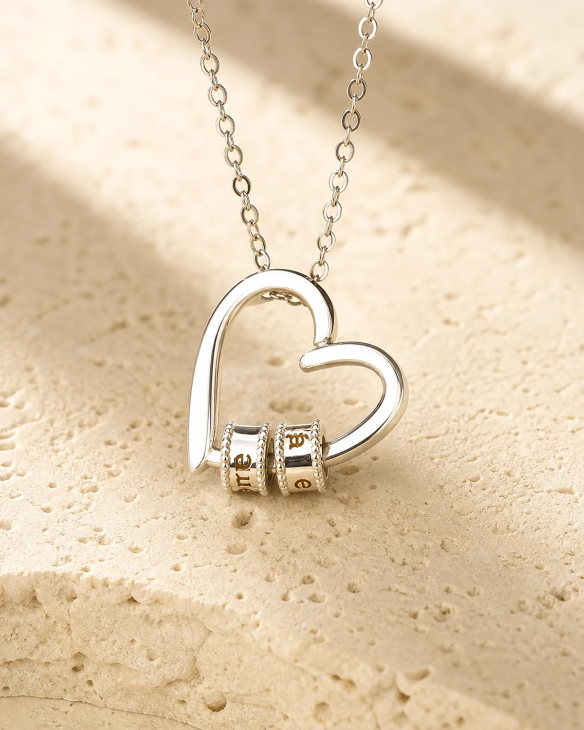 Personalized gathered hearts necklace with engraved family names