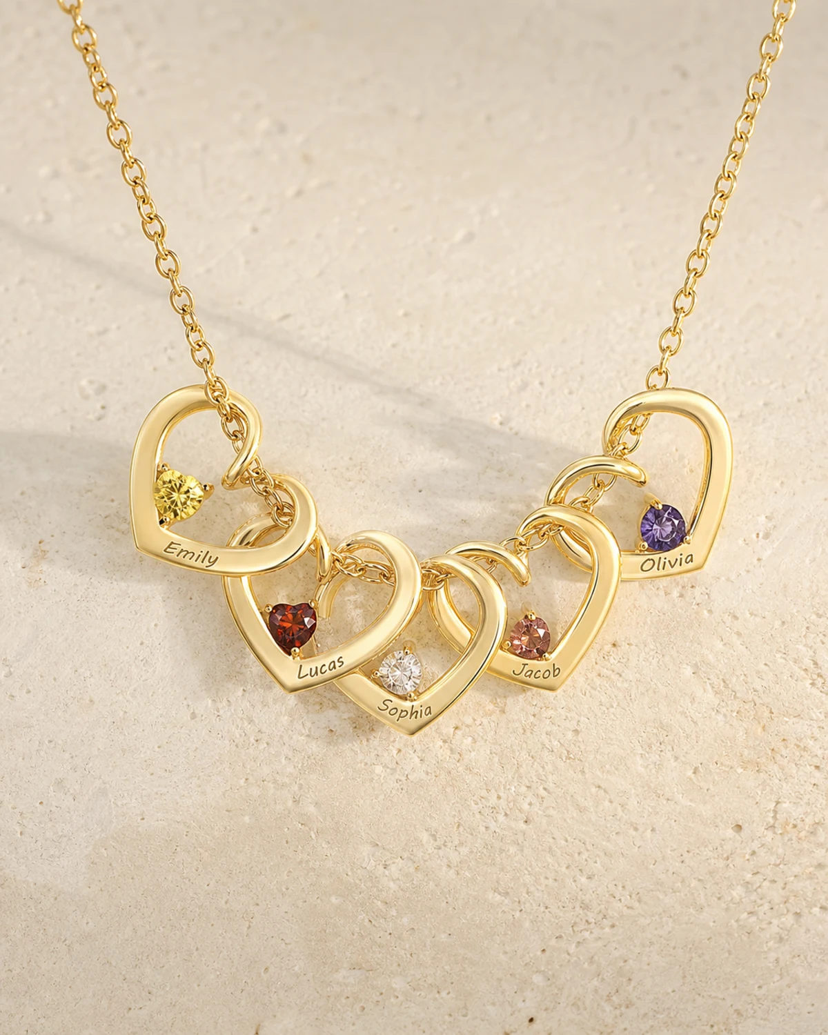 Gold twisted heart necklace with engraved family names and birthstones