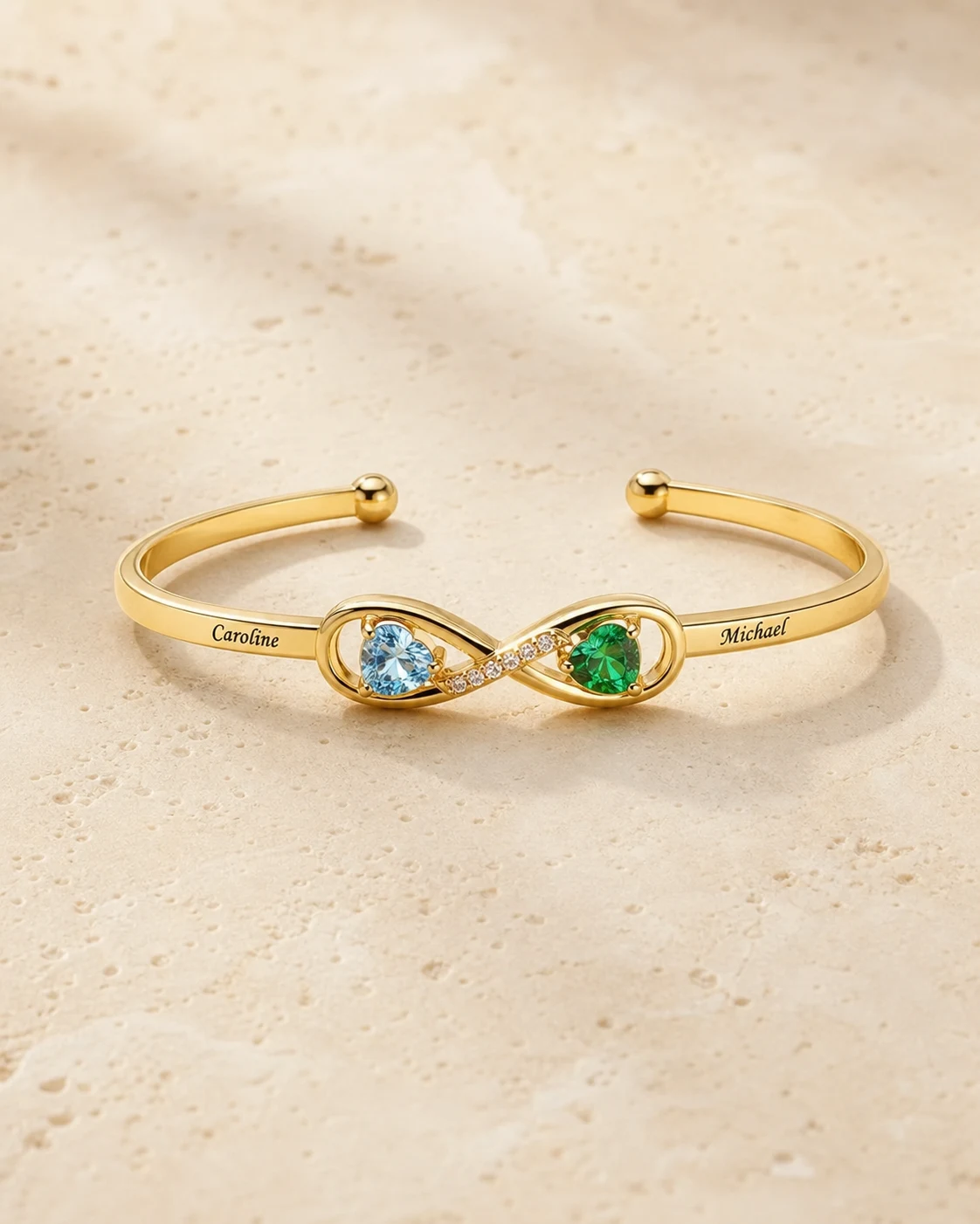 Gold tone open-heart cuff with two engraved names and two birthstones
