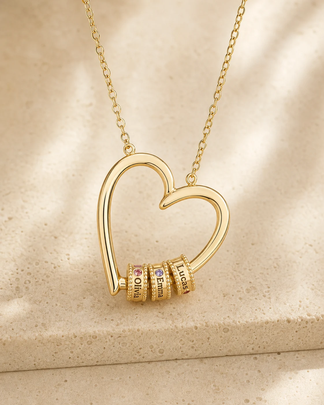 Gold tone open-heart necklace with individually engraved name beads