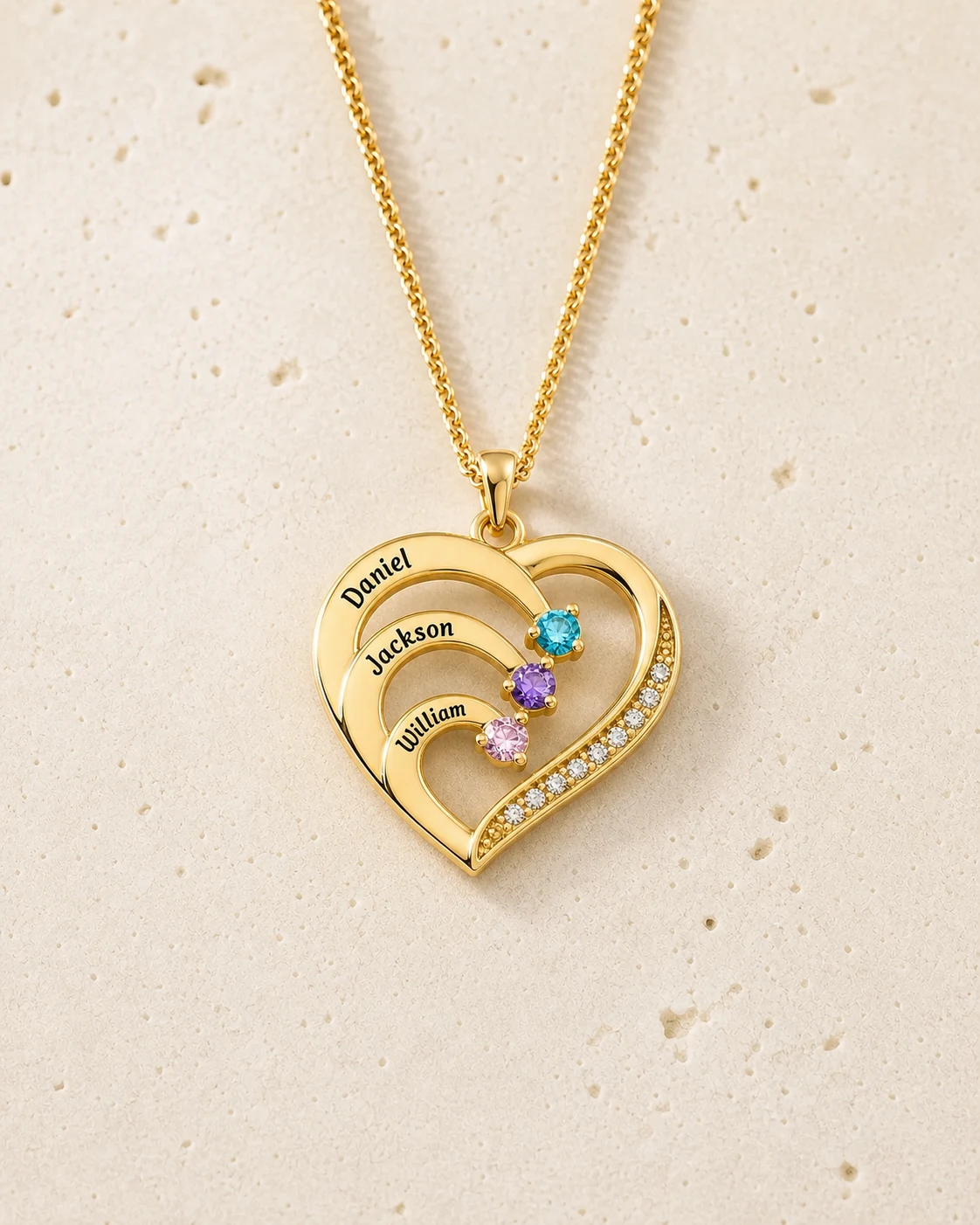 Gold tone family heart necklace with three engraved names and matching birthstones
