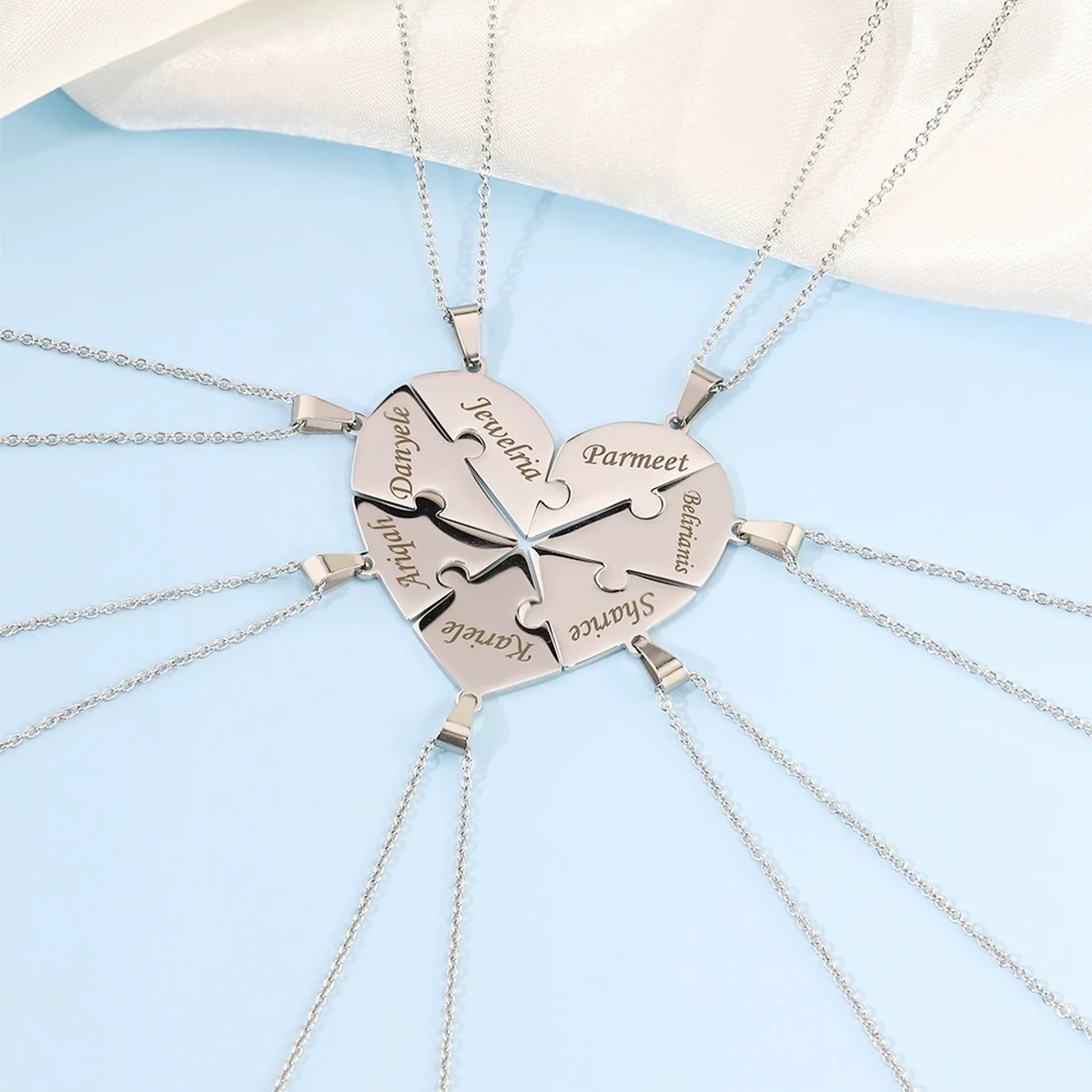 Together Heart Puzzle Necklace showing separate engraved pieces arranged into one complete heart