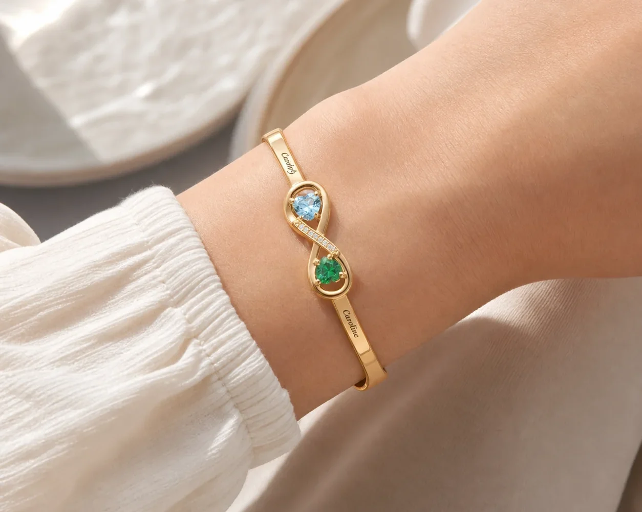 Open heart birthstone cuff with two personalized ends shown on a wrist