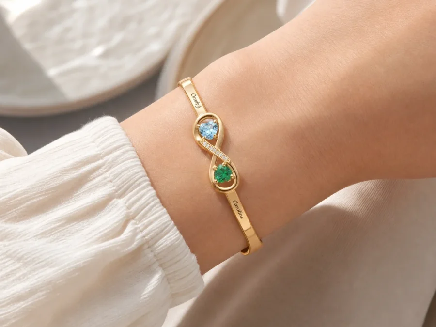 Open heart birthstone cuff with two personalized ends shown on a wrist