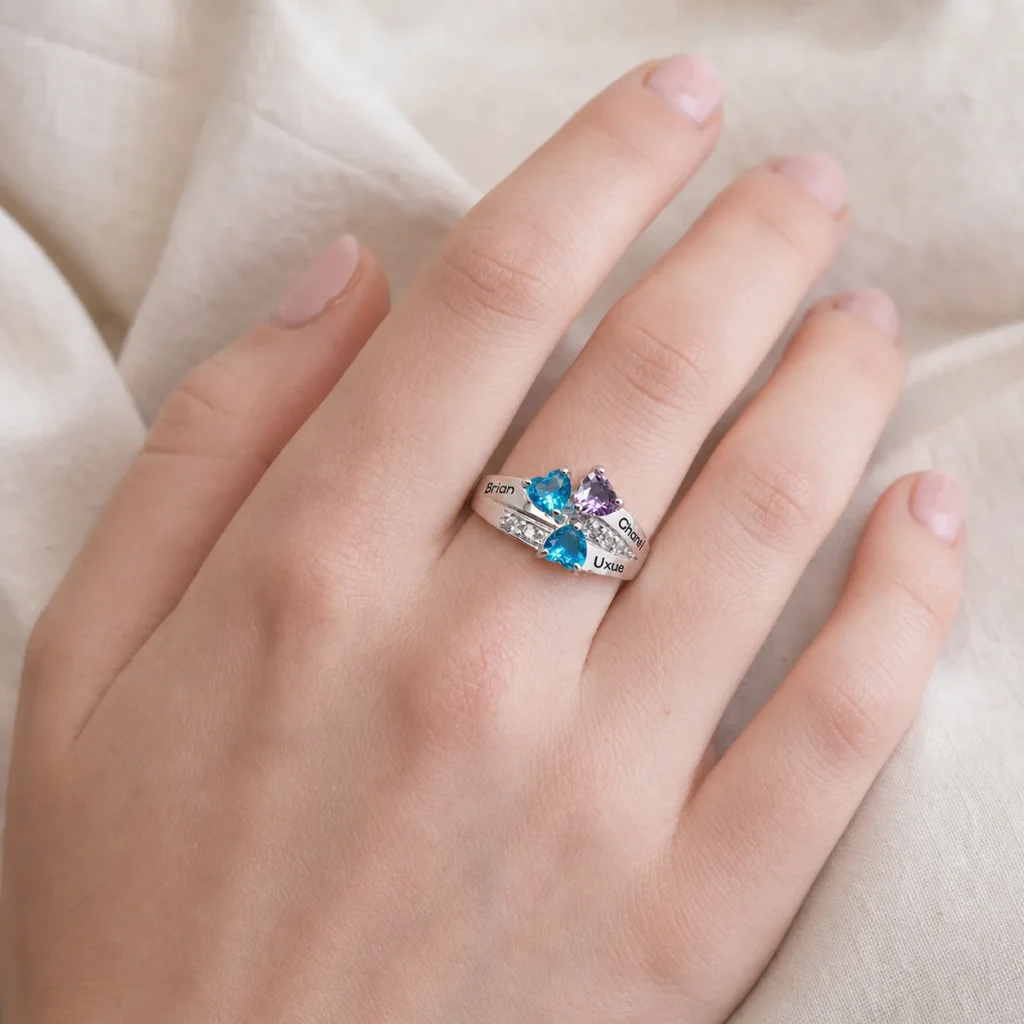 Family constellation name ring with a cluster of colorful simulated birthstone accents shown on a hand