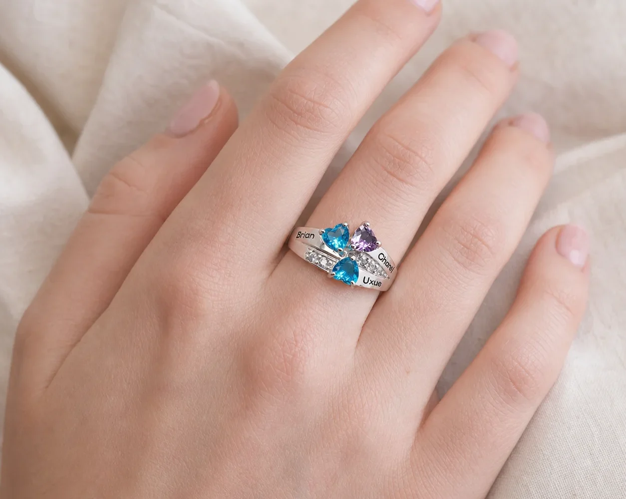 Family constellation name ring with a colorful birthstone cluster shown on a hand