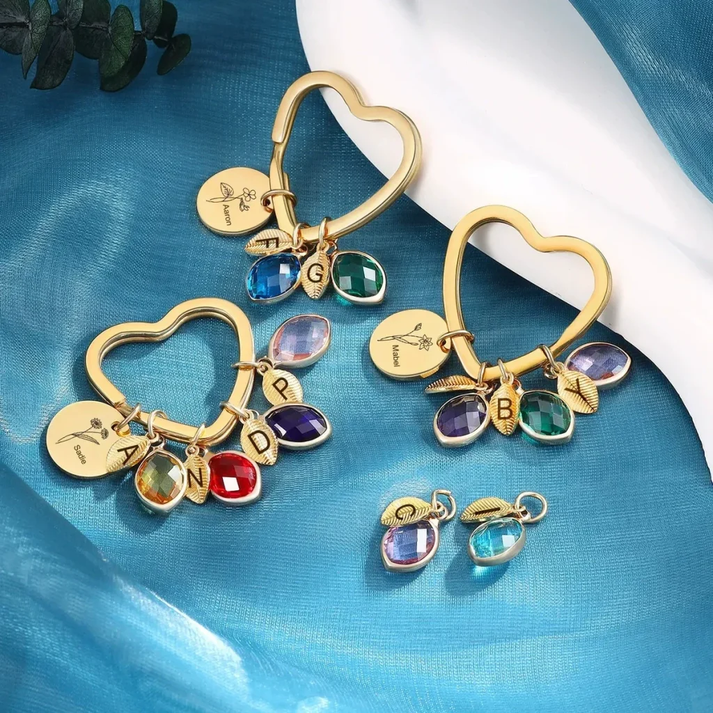 Family branch design guide showing an adjustable bangle, round keyring, and heart keyring with personalized leaves