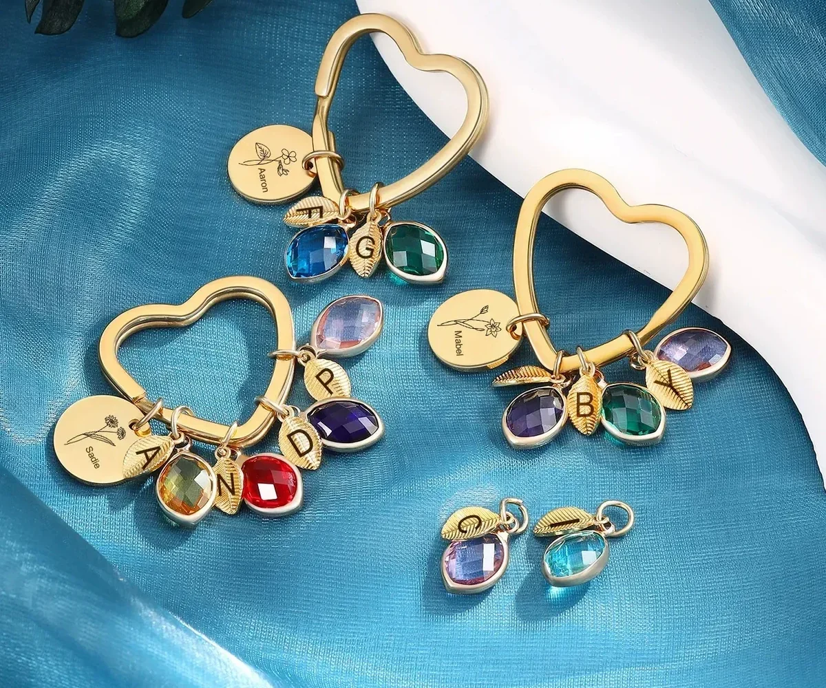 Family branch bangle and keyring formats with engraved discs, leaves, and simulated birthstone charms