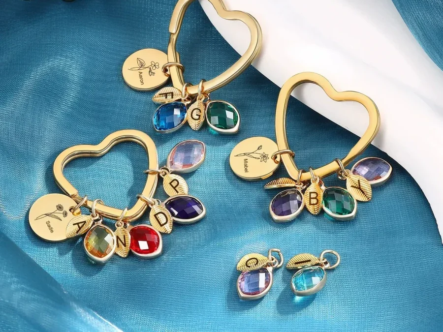 Family branch bangle and keyring formats with engraved discs, leaves, and simulated birthstone charms