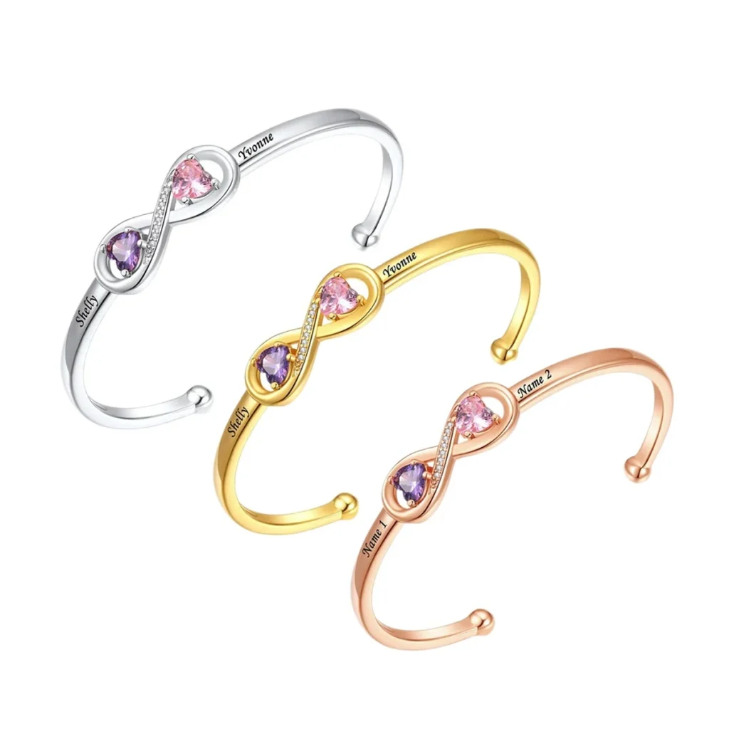 Three plated tone options for an engraved open heart cuff with simulated birthstone accents