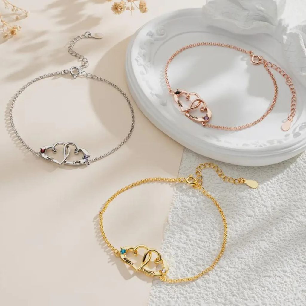 Personalized double heart bracelet with two engraved names and two birthstone accents in rose gold tone