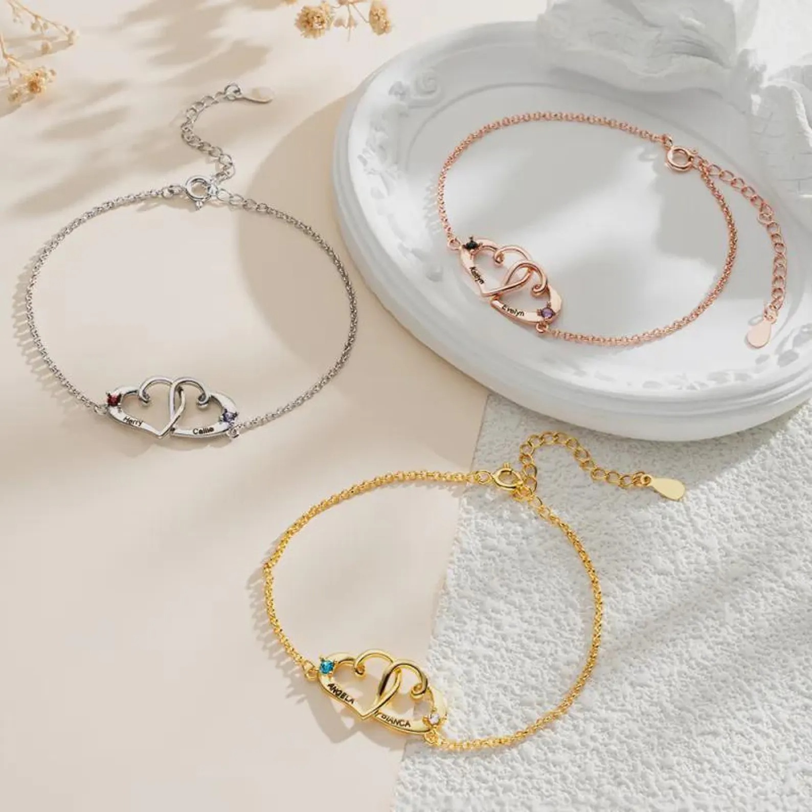 Personalized double heart bracelet with two engraved names and two birthstone accents in rose gold tone