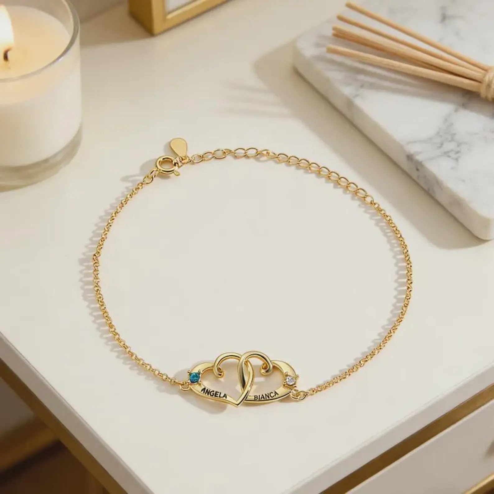 Personalized double heart bracelet with two engraved names and two birthstone accents in rose gold tone