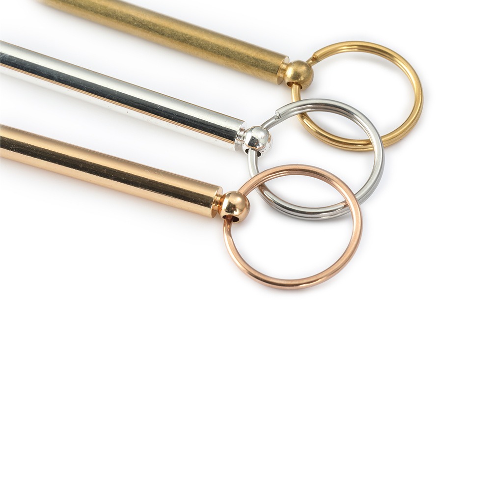 Engraved brass whistle keychain with a coil keyring and optional birthstone