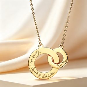 Interlocking double ring necklace in rose gold with an engraved name and a birthstone accent