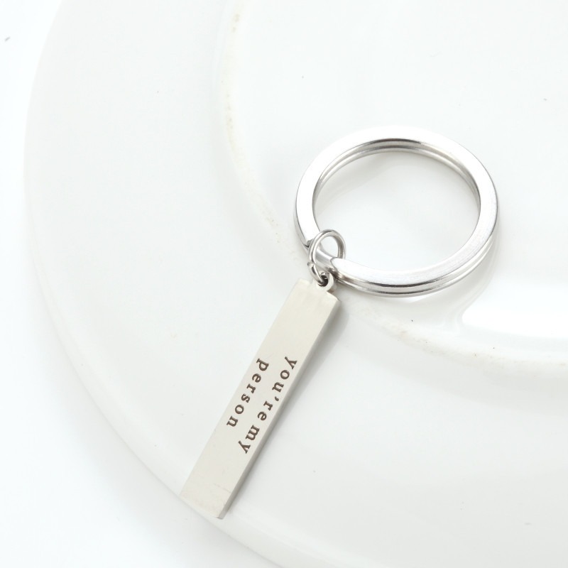 Stainless steel keychain with an engraved name and a small birthstone charm
