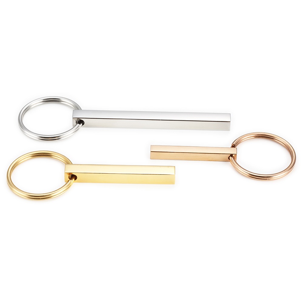 Polished stainless steel bar keychain engraved with a name and a small birthstone