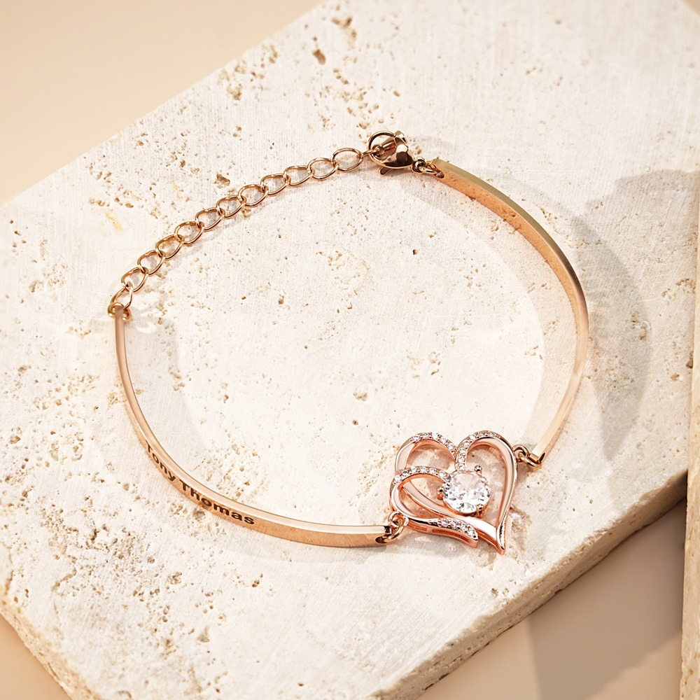 Stainless steel bracelet with two CZ heart charms engraved with names and birthstones