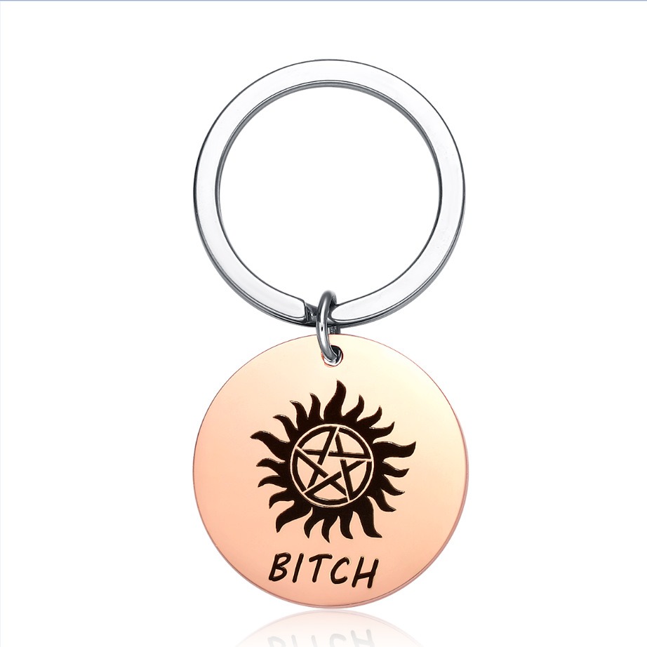 Round stainless steel keychain charm engraved with a name and set with a birthstone