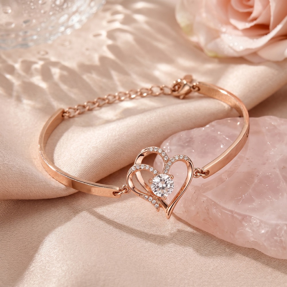 Stainless steel bracelet with two CZ heart charms engraved with names and birthstones