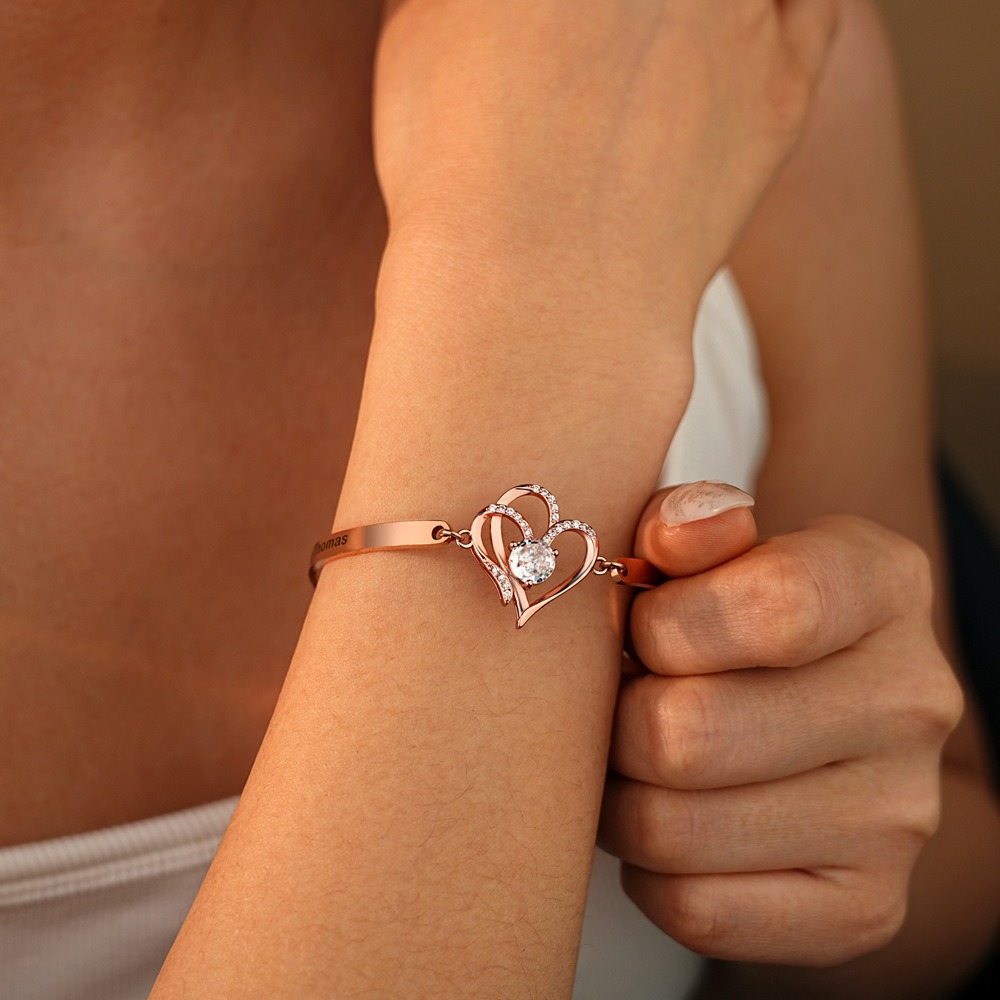 Stainless steel bracelet with two CZ heart charms engraved with names and birthstones