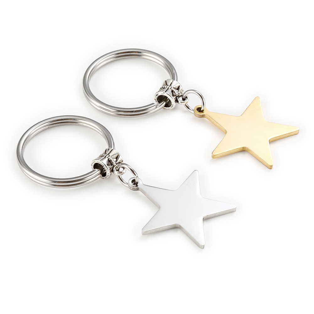 Stainless steel star keychain engraved with a name, shown in gold-tone and steel-tone finishes