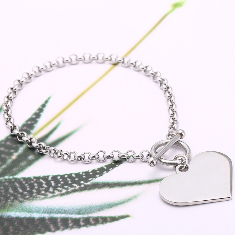 Double sided photo heart bracelet with engraved message in rose gold