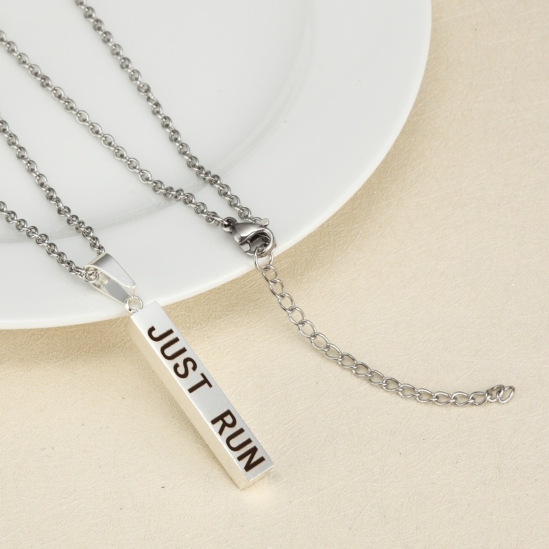 Vertical stainless steel bar necklace with custom single line engraving and optional birthstone, shown in gold tone