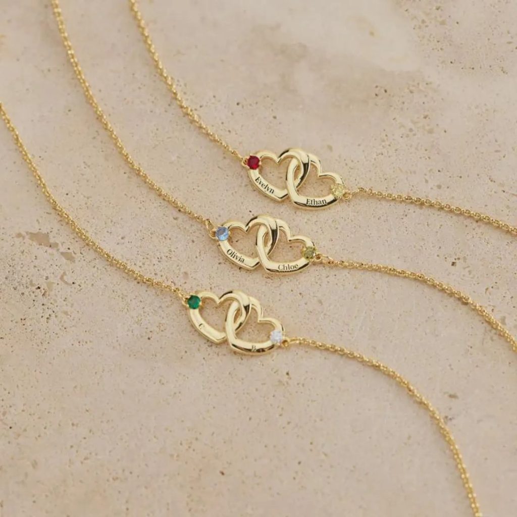 Personalized double heart bracelet with two engraved names and two birthstone accents in rose gold tone