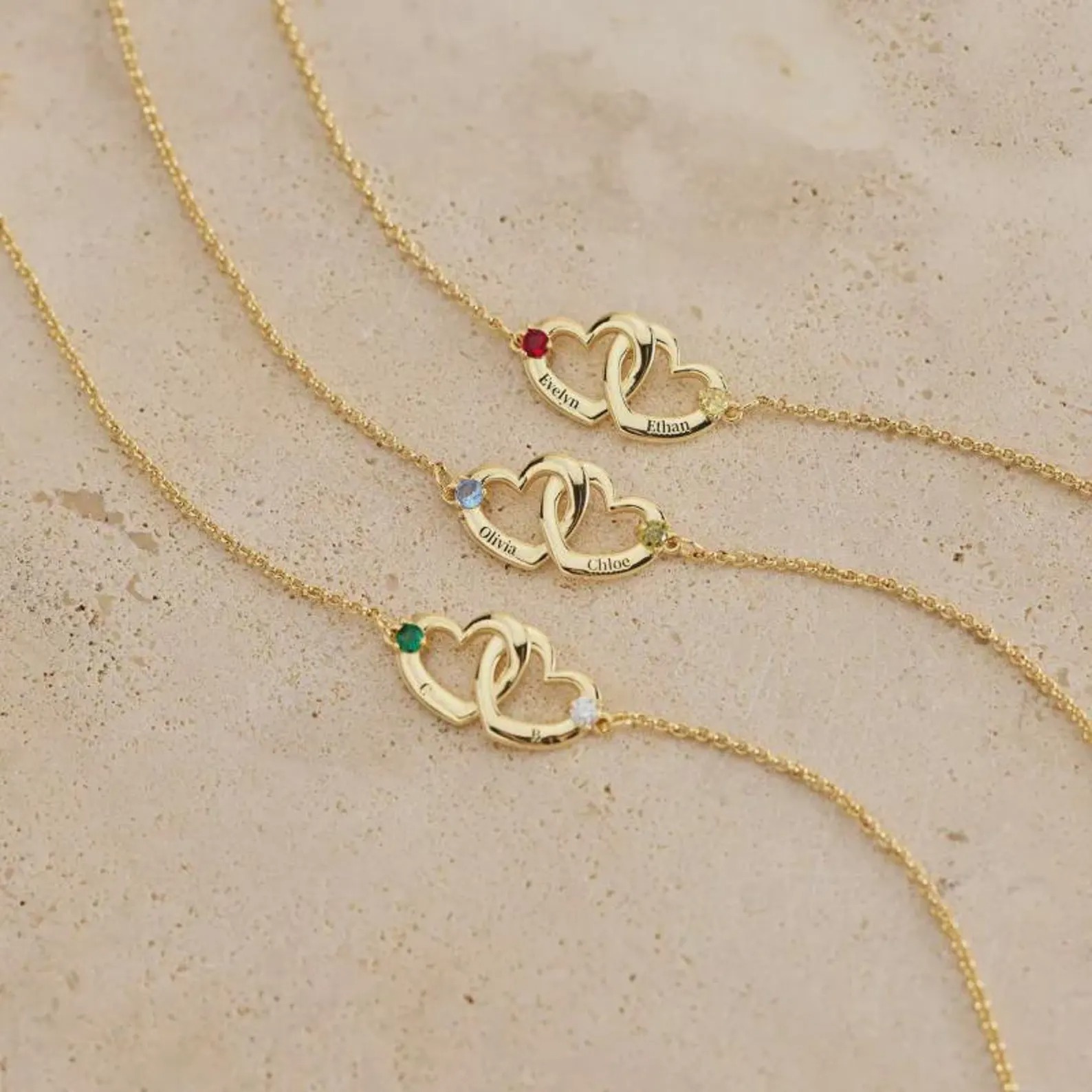 Personalized double heart bracelet with two engraved names and two birthstone accents in rose gold tone