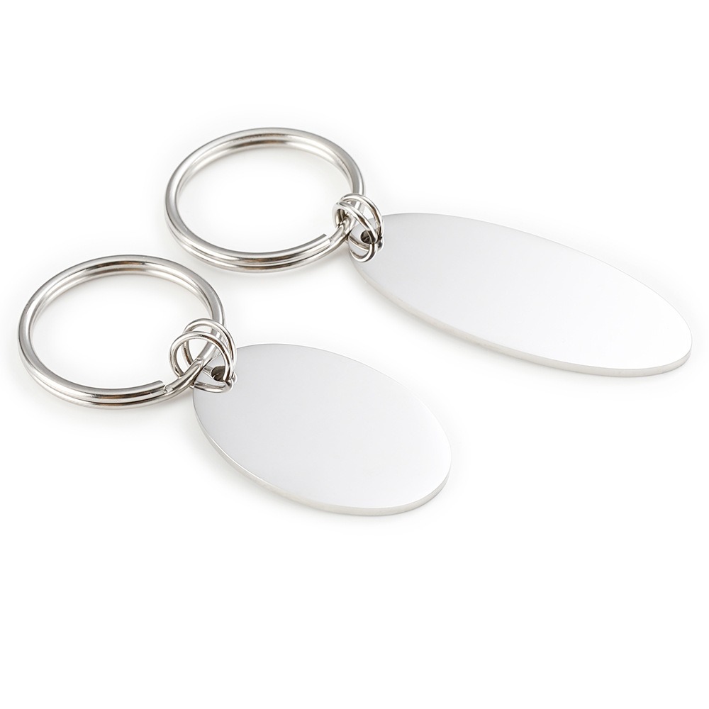 Polished oval stainless steel keychain engraved with a name and a single birthstone