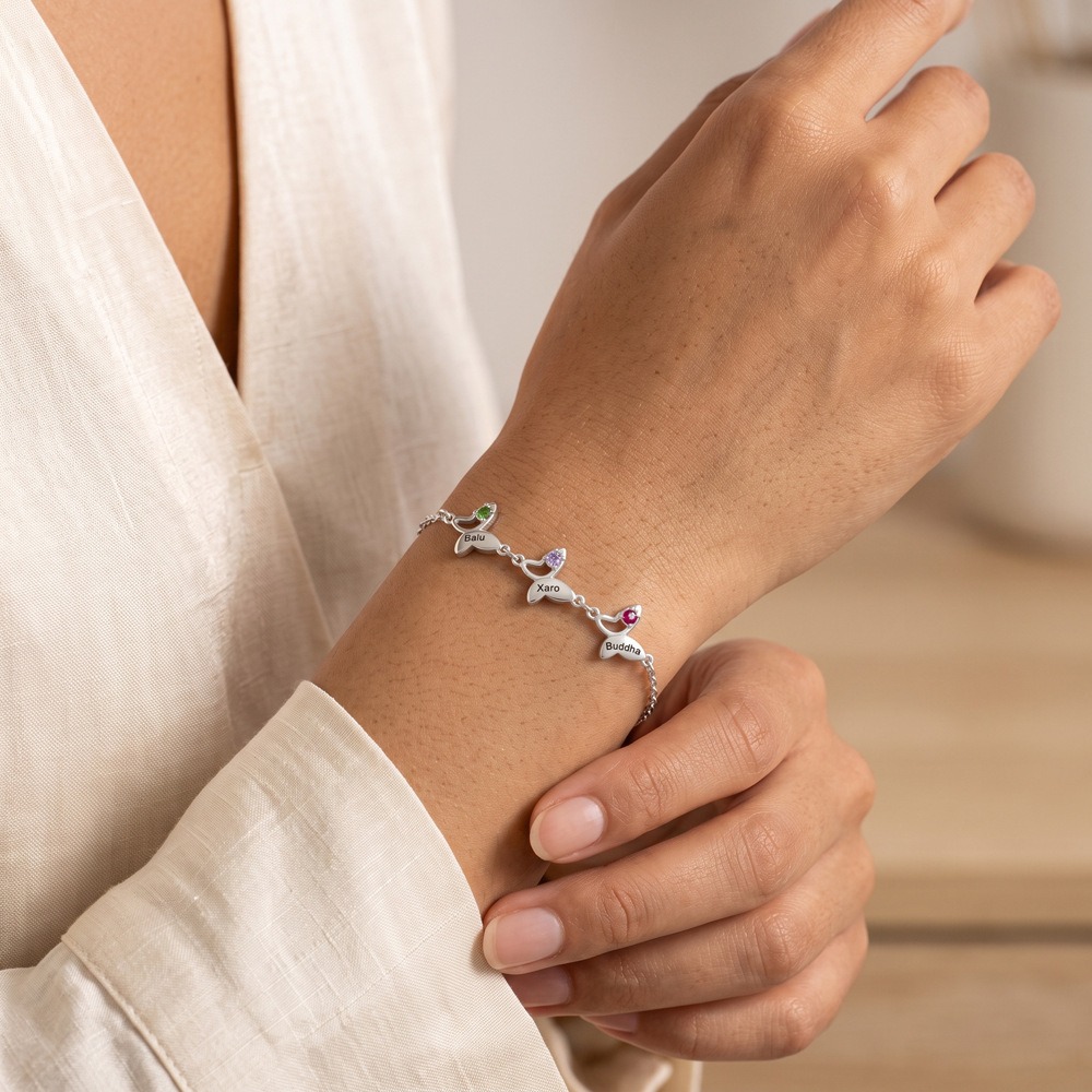 Butterfly bracelet with an engraved name and birthstone accent in gold tone