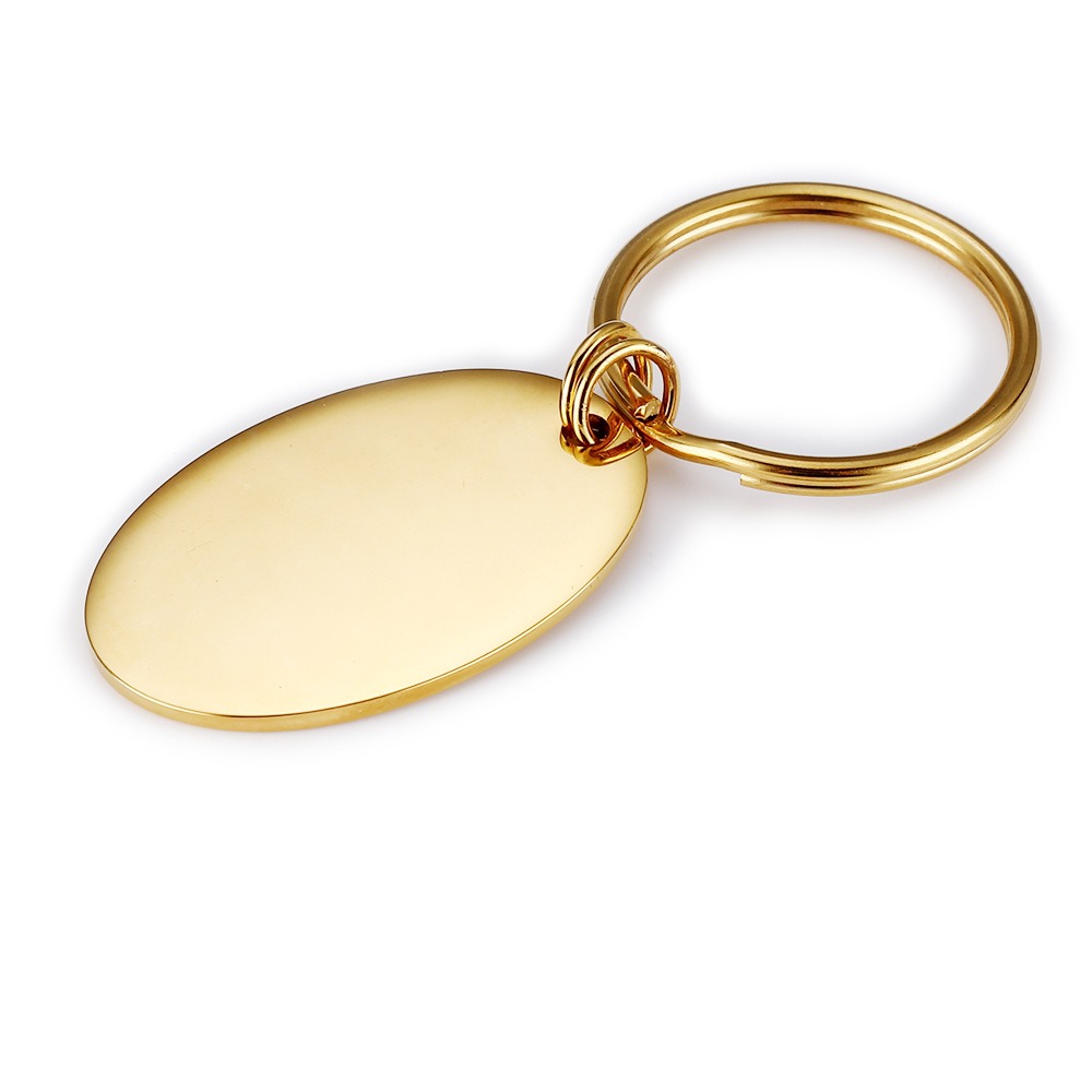 Polished oval stainless steel keychain engraved with a name and a single birthstone