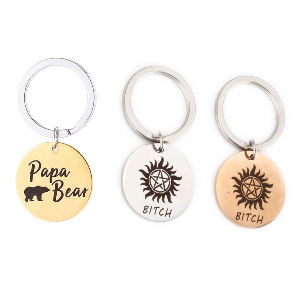 Round stainless steel keychain charm engraved with a name and set with a birthstone