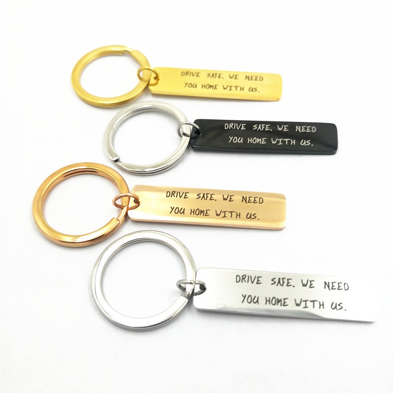 Stainless steel keychain with an engraved name and a small birthstone charm