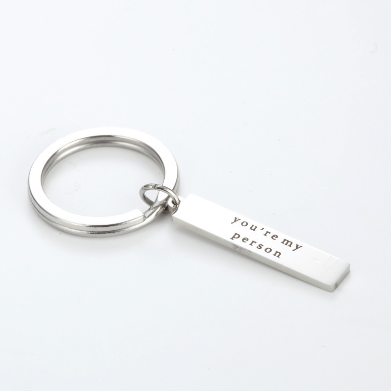 Stainless steel keychain with an engraved name and a small birthstone charm
