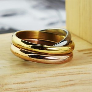 Three interlocked stainless steel ring bands in silver, gold and rose gold tones