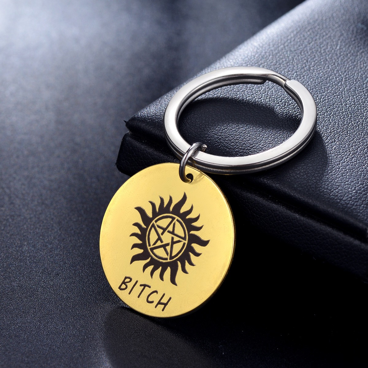 Round stainless steel keychain charm engraved with a name and set with a birthstone