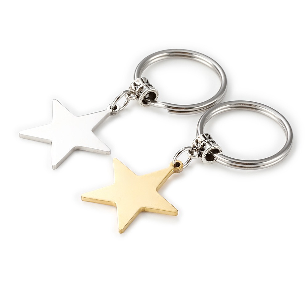 Stainless steel star keychain engraved with a name, shown in gold-tone and steel-tone finishes