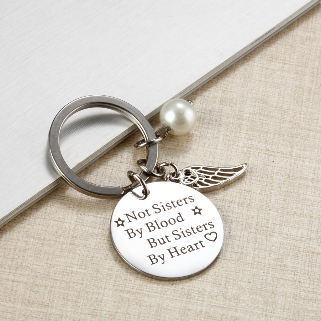 Engraved wing keychain in polished stainless steel with optional pearl detail and birthstone