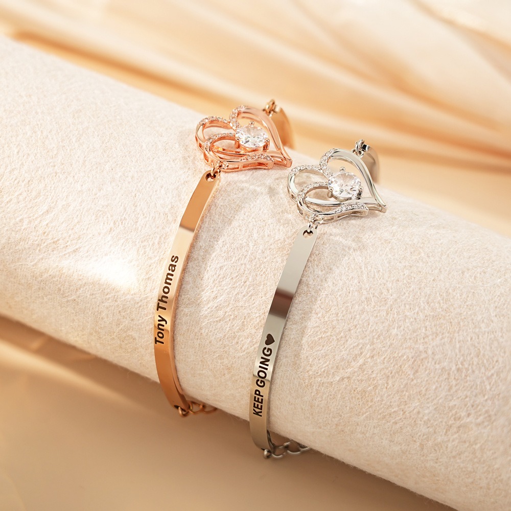 Stainless steel bracelet with two CZ heart charms engraved with names and birthstones