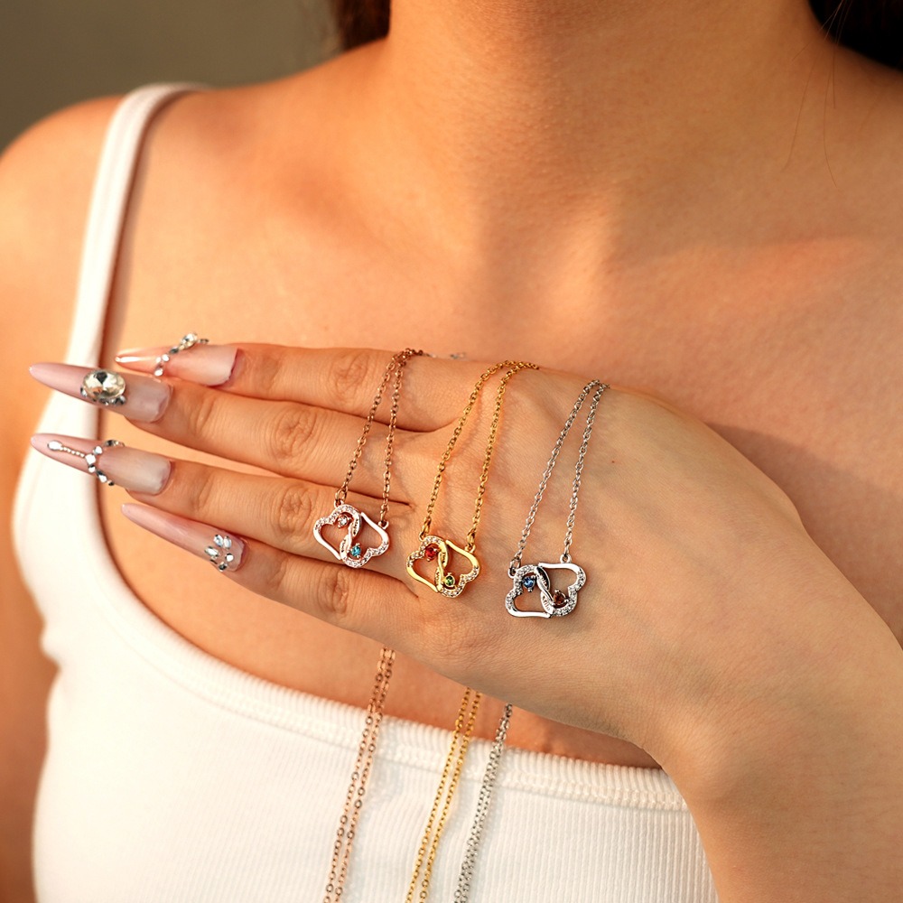 Two interlocking heart name necklace with a birthstone accent on a cross chain