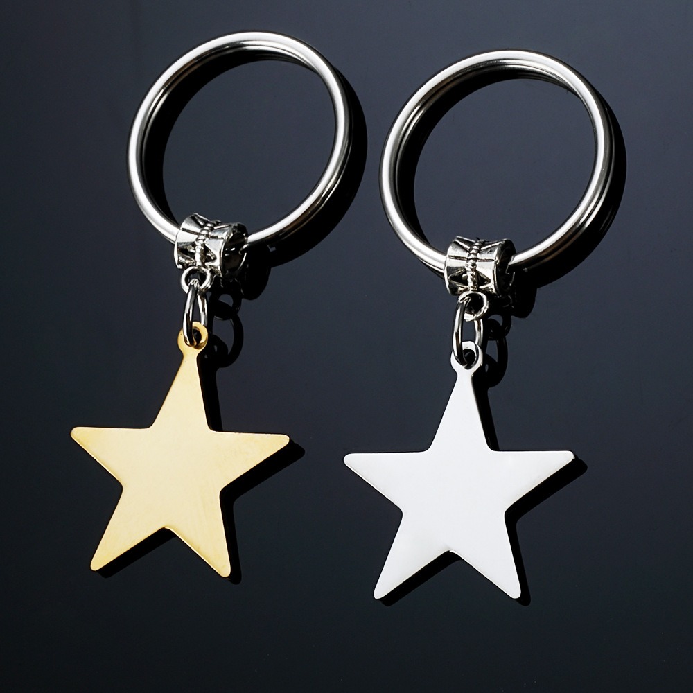 Stainless steel star keychain engraved with a name, shown in gold-tone and steel-tone finishes