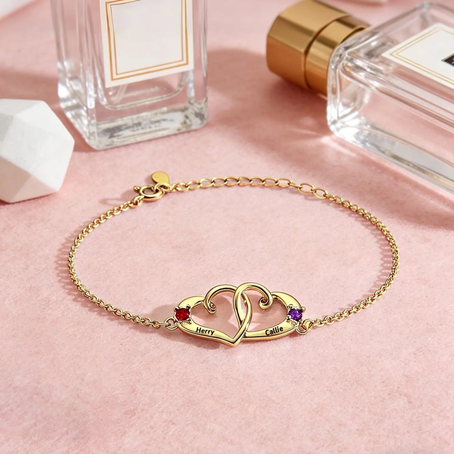 Personalized double heart bracelet with two engraved names and two birthstone accents in rose gold tone