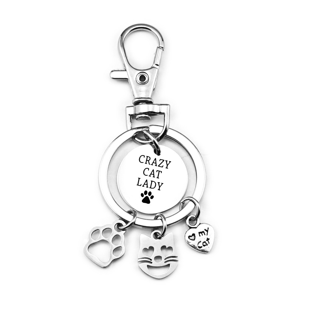 Stainless steel cat paw keychain with an engraved name and birthstone charm