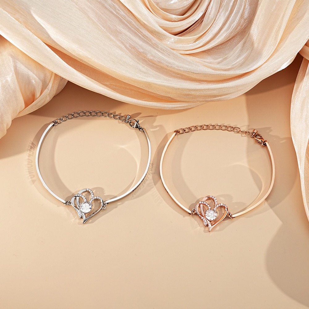Stainless steel bracelet with two CZ heart charms engraved with names and birthstones