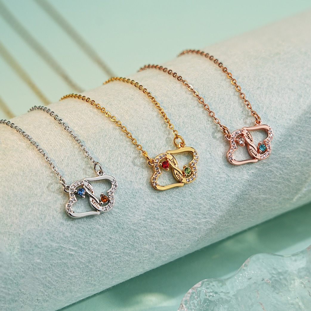 Two interlocking heart name necklace with a birthstone accent on a cross chain