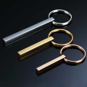 Polished stainless steel bar keychain engraved with a name and a small birthstone