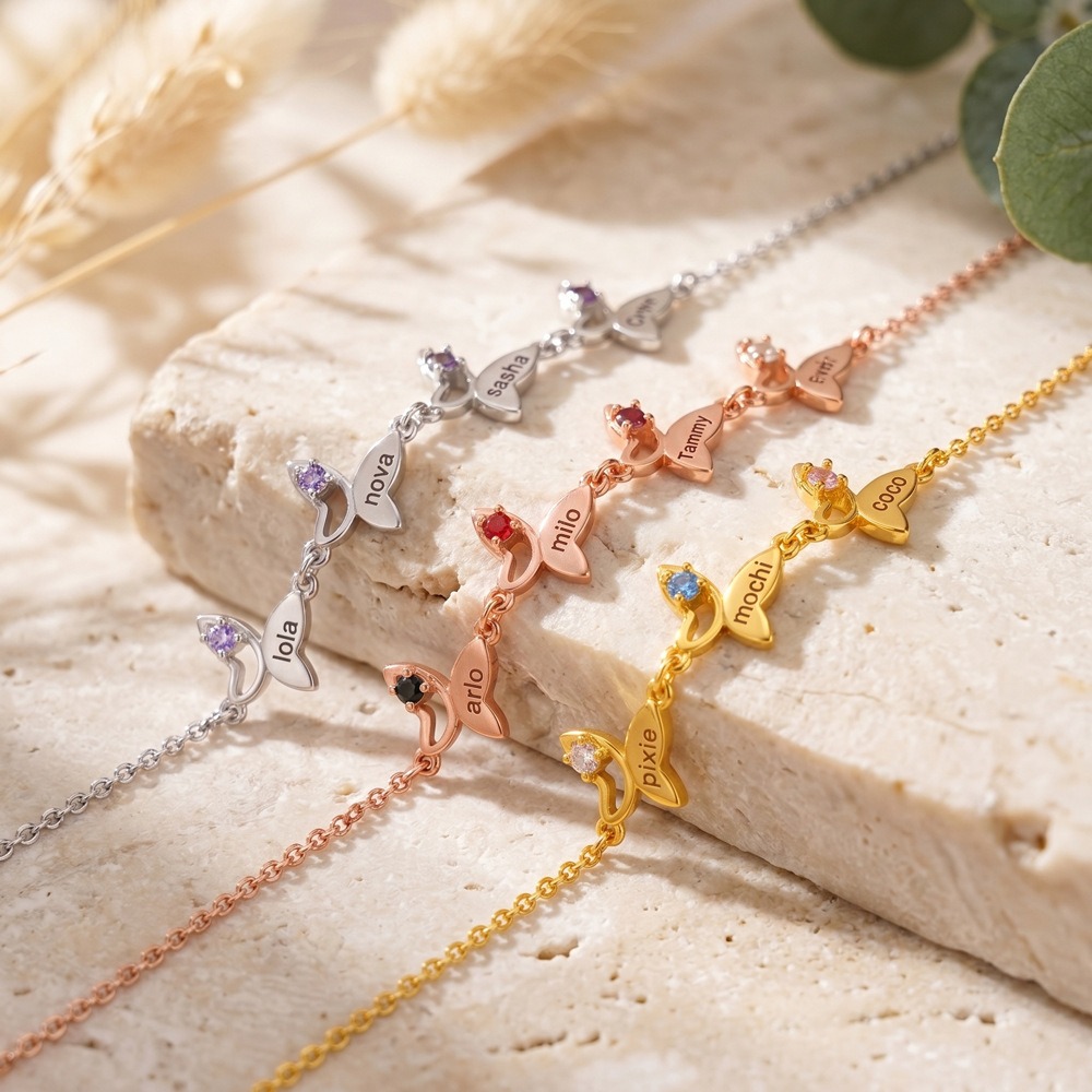 Butterfly bracelet with an engraved name and birthstone accent in gold tone